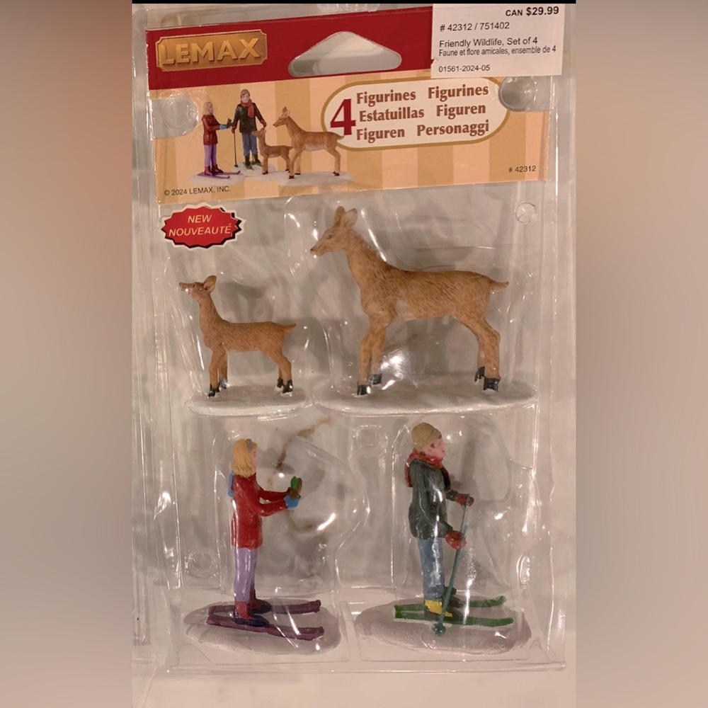 Lemax 4 figurines. A couple of skies and couple of deers